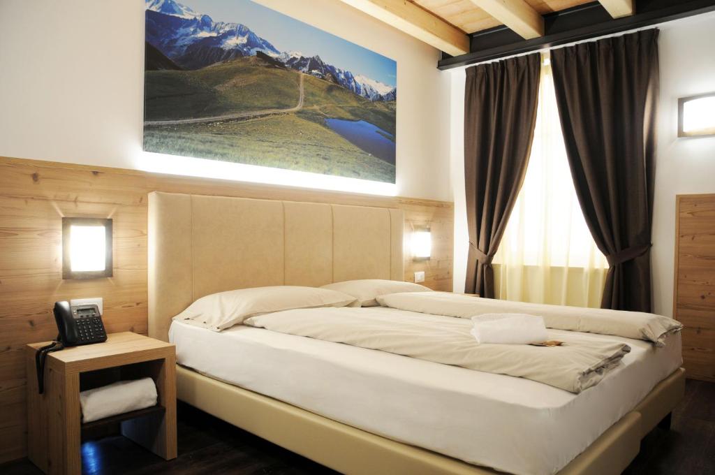 埃多洛TOURING HOTEL & SPA的卧室配有一张挂在墙上的床铺