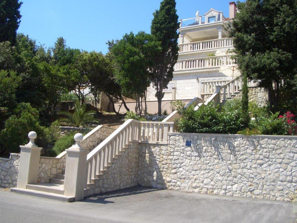 科尔丘拉Villa Jade Apartments FRONT ROW SEA VIEW - WALK TO KORCULA OLD TOWN的建筑前有楼梯的石墙