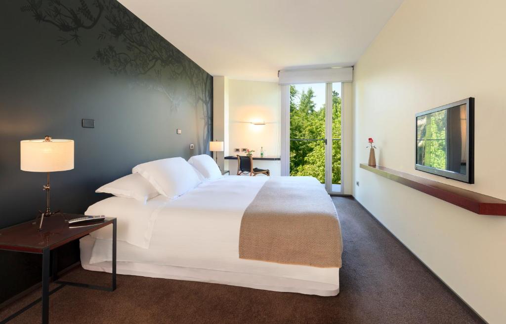 圣地亚哥伊斯梅尔酒店的卧室设有一张白色大床和一扇窗户。