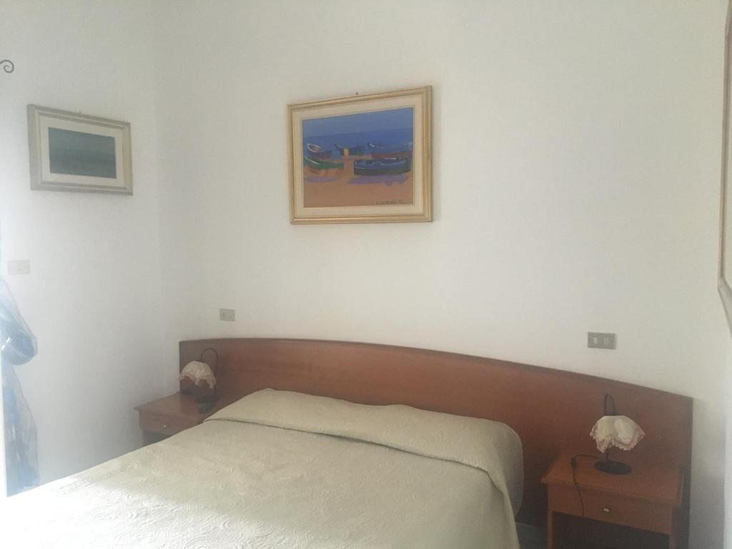 佩斯基奇罗坎达城堡旅馆的卧室配有一张床,墙上挂着一幅画