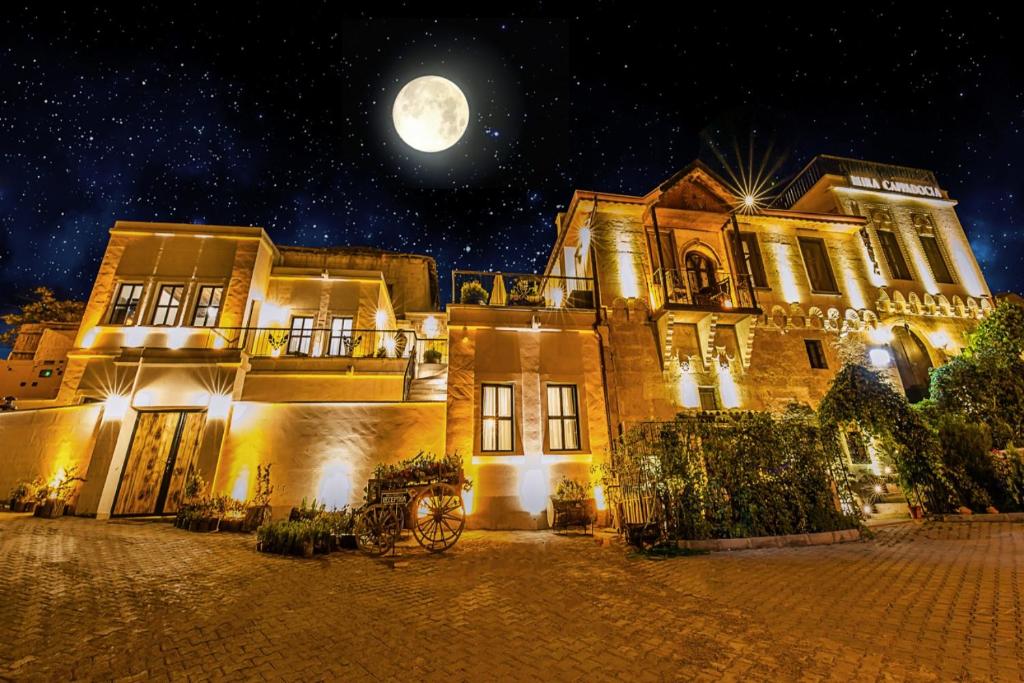 阿瓦诺斯Mira Cappadocia Hotel的天空中满月的老房子