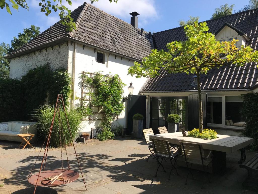 许尔斯霍斯特B&B Het Wellnest的院子里带桌椅的房子