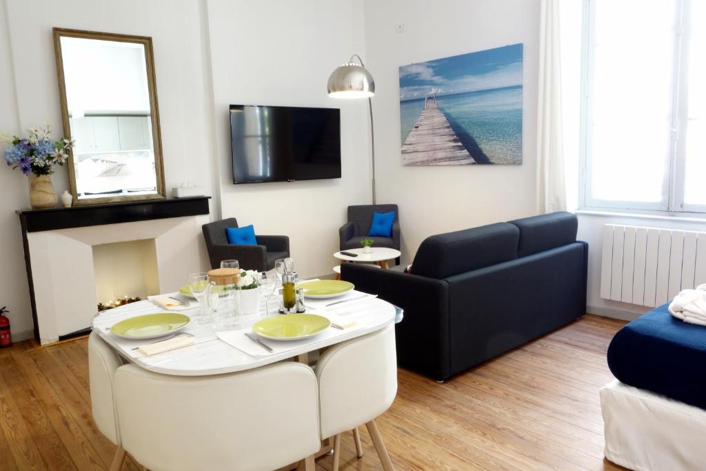阿尔勒Arles Holiday - Le Studio Chic的客厅配有桌子和沙发