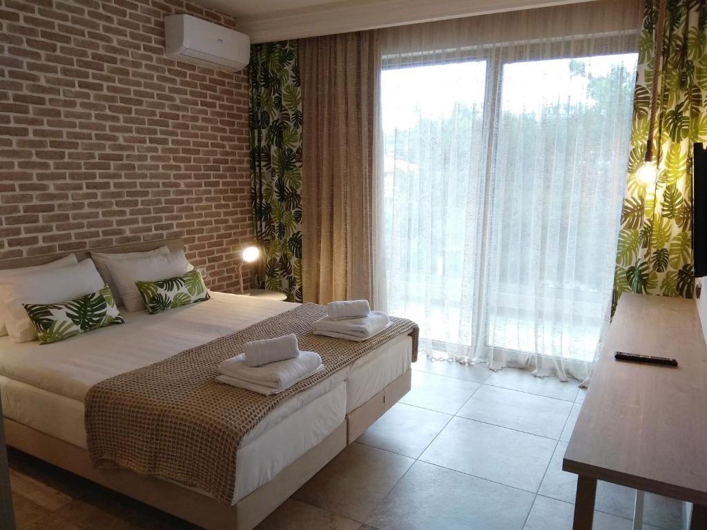 奥马斯帕纳吉亚斯The Archontariki的一间卧室设有一张床和一个大窗户
