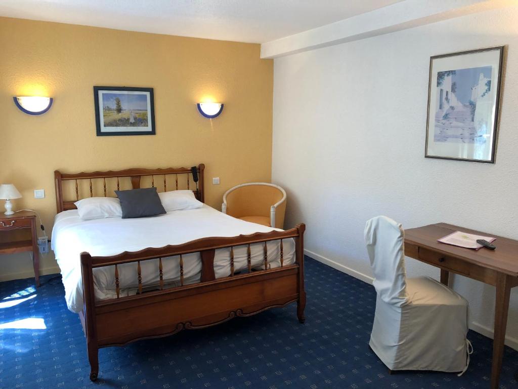 讷韦尔公园别墅酒店的酒店客房配有一张床铺、一张桌子和一张书桌。