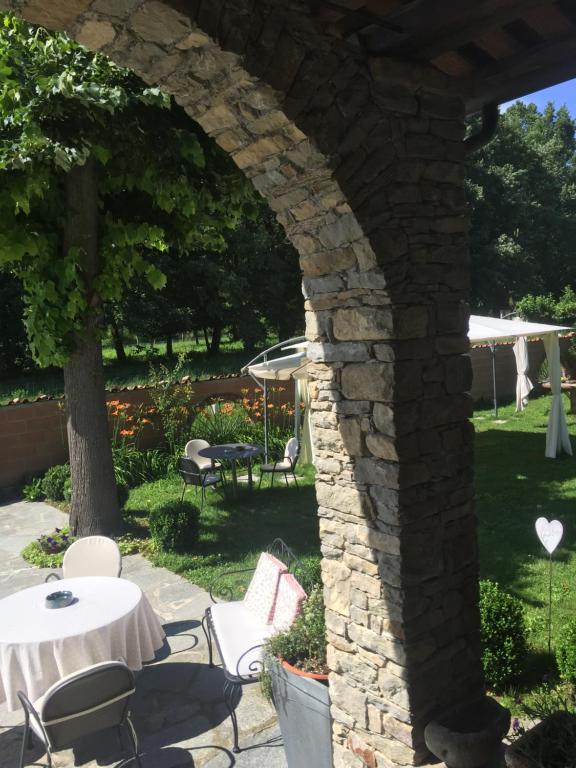 卡斯塔诺兰泽卡德尼斯酒店的庭院内带桌椅的石拱门