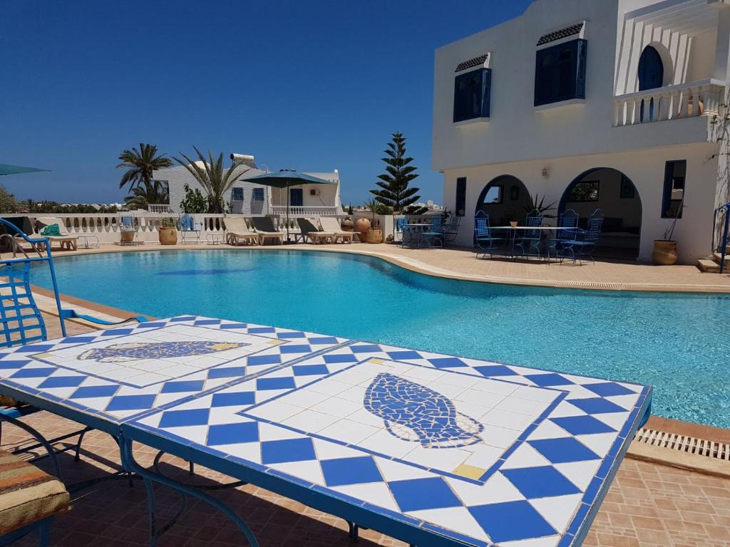 米多恩Dar Amphora Menzel的一个带蓝白色桌子的游泳池