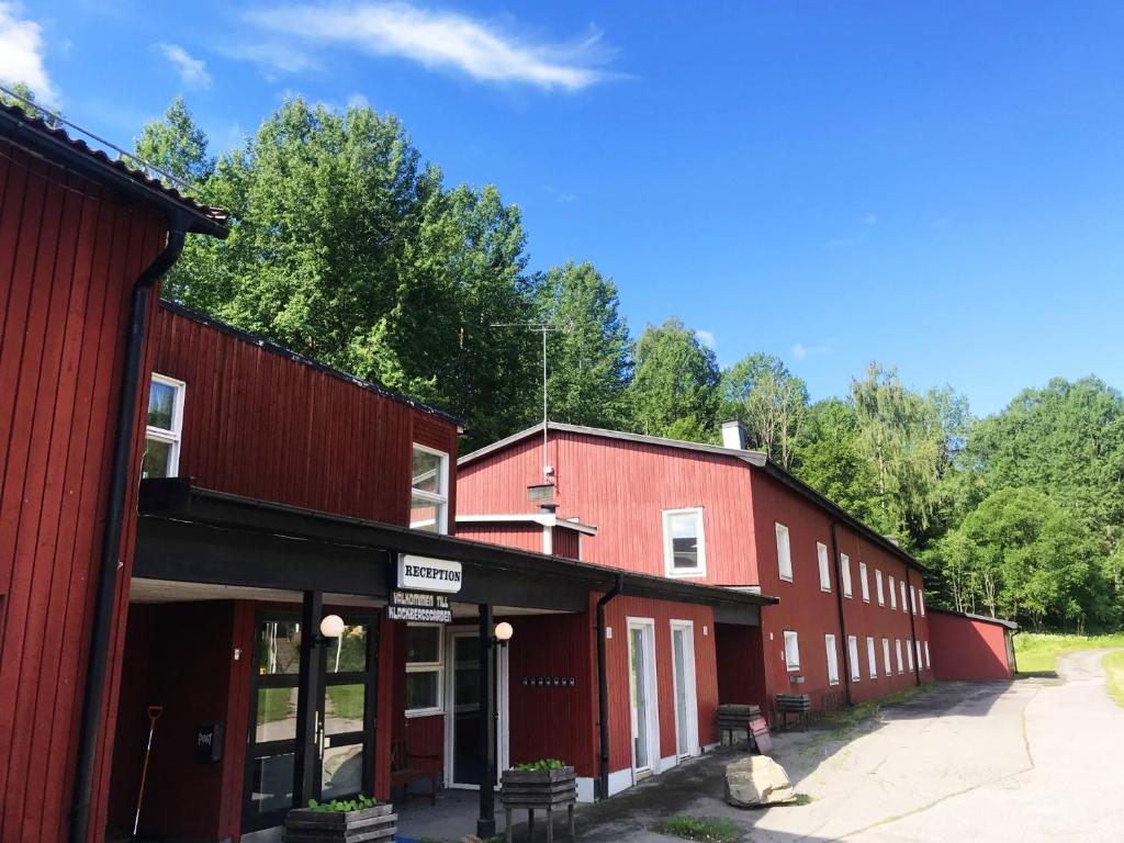 NorbergKlackbergsgården的背景中一排种有树木的红色建筑