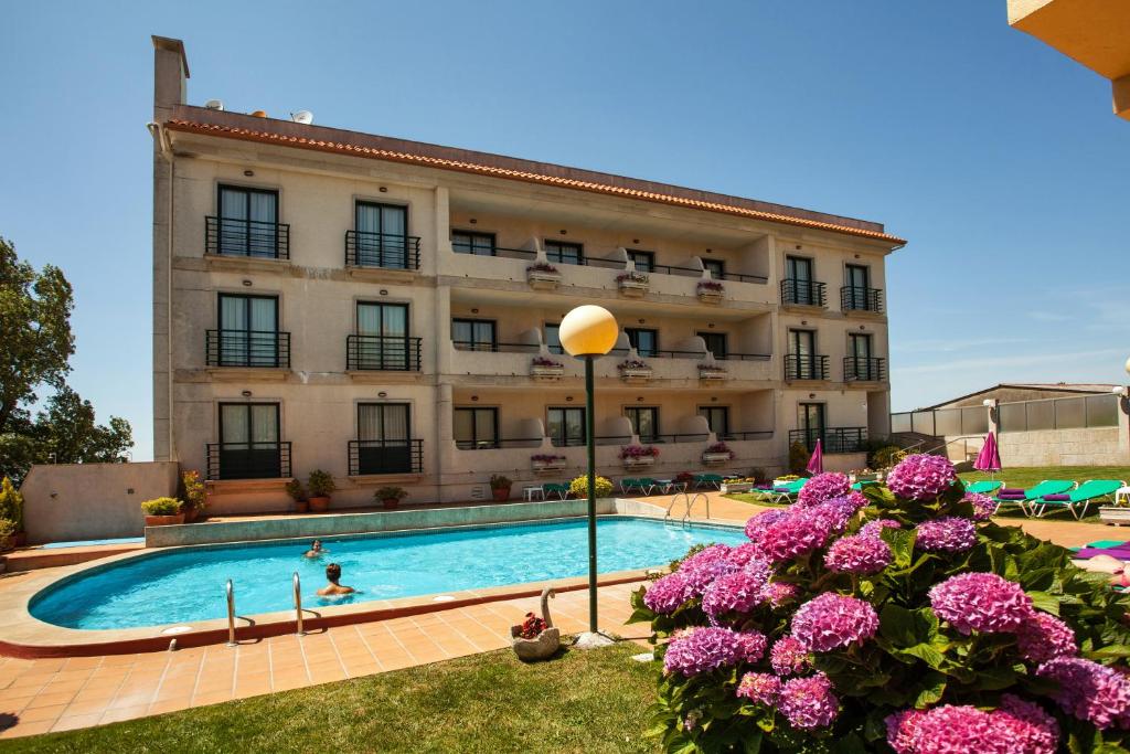 Aios奥卡维尔玛尔就对岸的大楼前设有游泳池的酒店