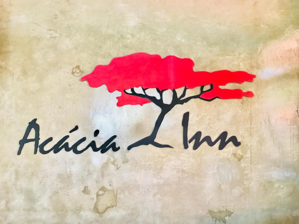 马普托Acacia Inn GuestHouse的红树上写着葡萄干草的画