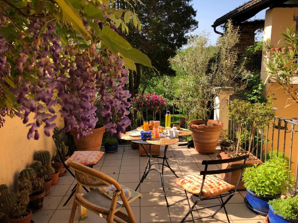 AstanoChez Marianne "chambres d'hôtes"的庭院配有桌椅和植物