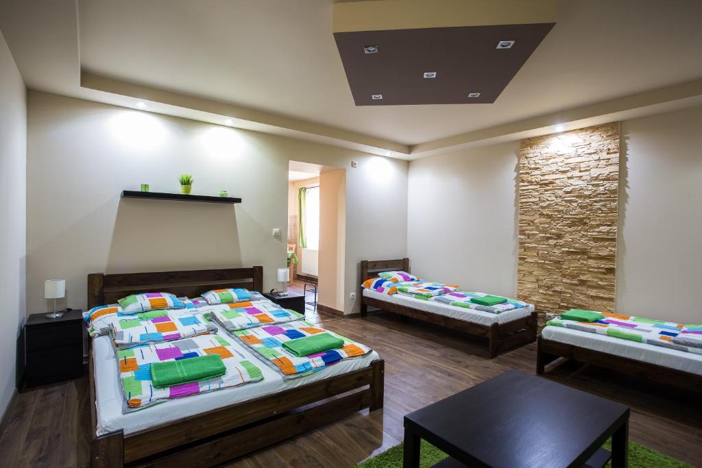 托考伊Türkiz Apartman的一间设有三张床的房间,里面装有黑板
