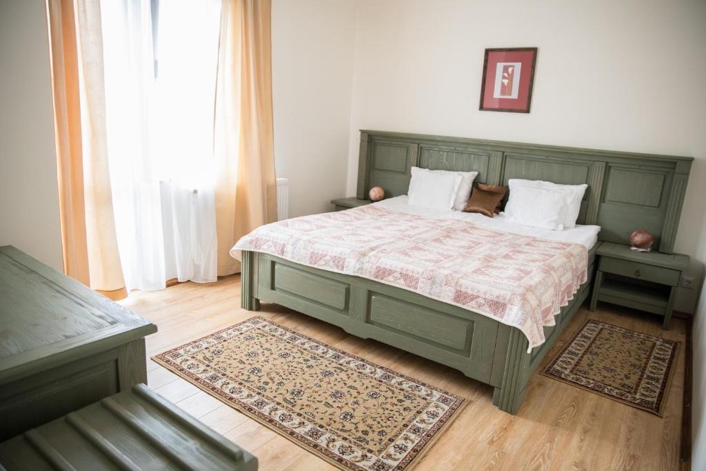 沃尔托普Pensiunea Panoramic的一间卧室配有带两个枕头的绿色床