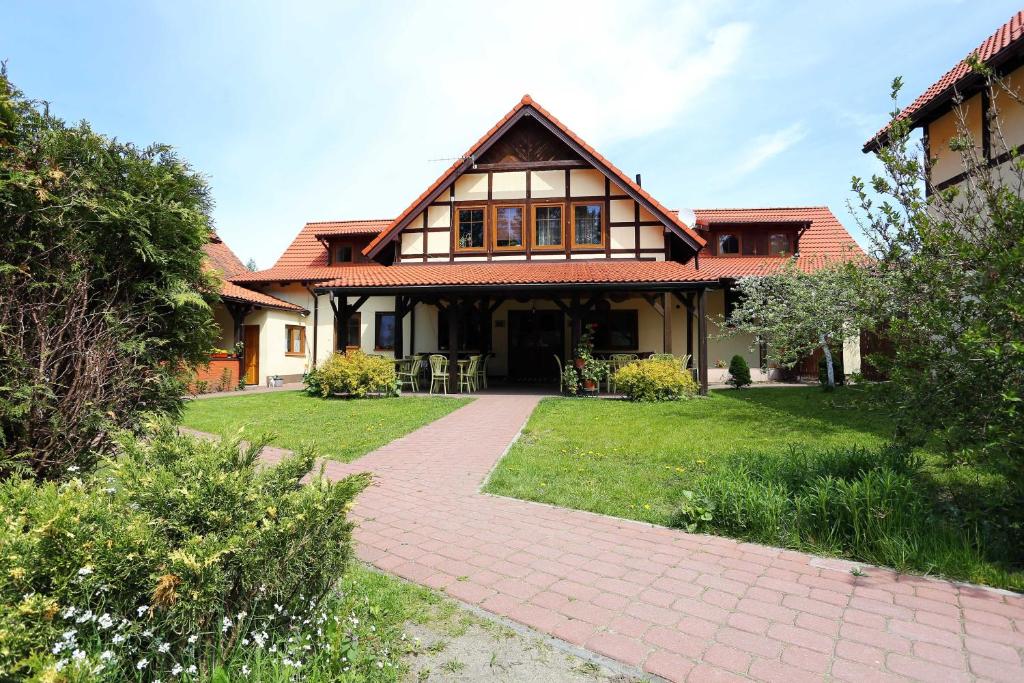 鲁恰内尼达GOŚCINIEC GŁODOWO的前面有砖砌人行道的房子