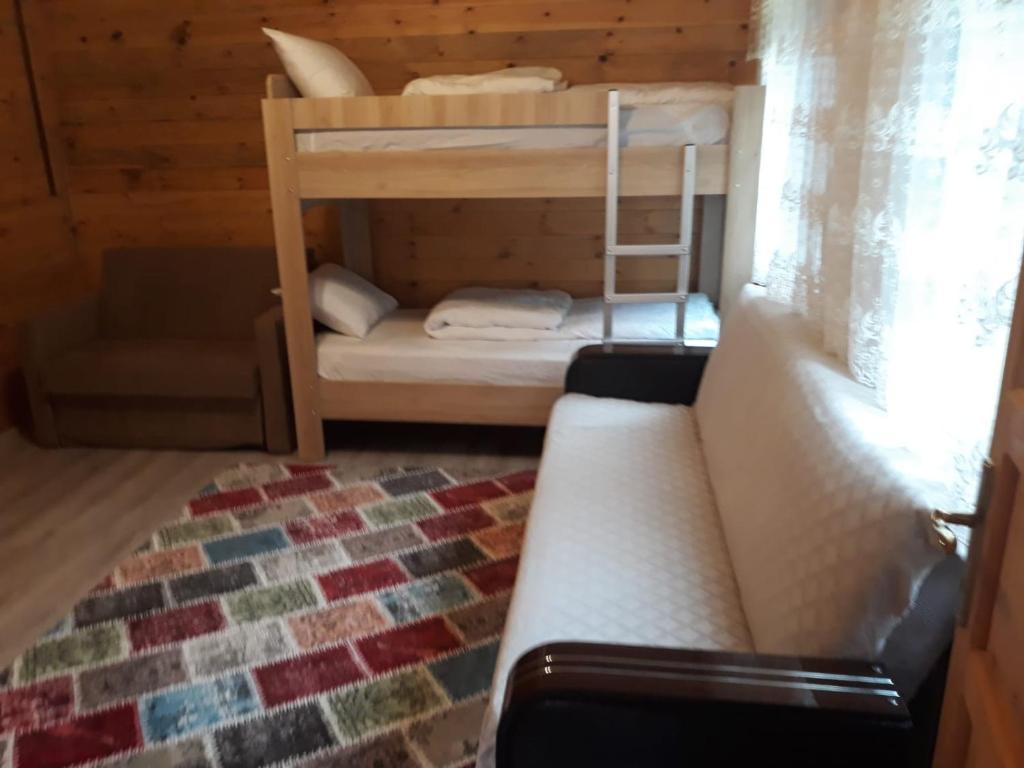 乌宗Katipogulları Apart的客房设有两张双层床和一张沙发。