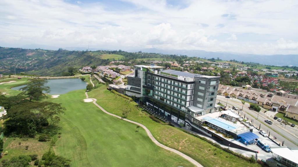 布卡拉曼加Punta Diamante Premium Hotel的享有大楼和高尔夫球场的空中景致