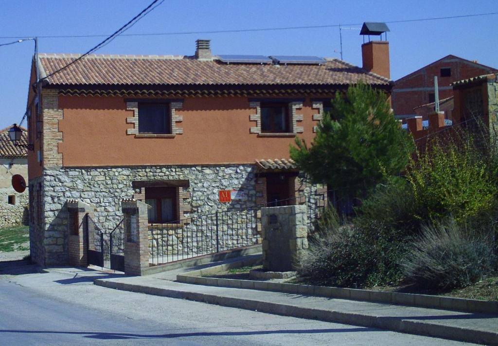 塞利亚Apartamentos turísticos La Fuensanta的街道边的一座老石屋