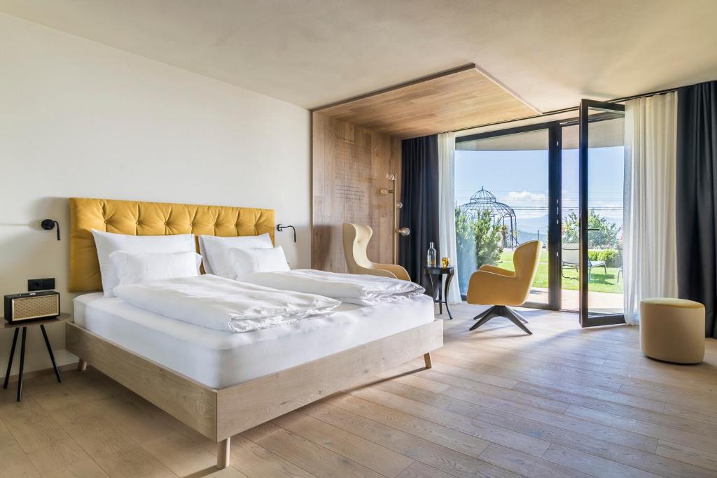 索普拉布扎诺Gloriette Guesthouse Hotel & Restaurant的一间卧室设有一张大床和一个大窗户