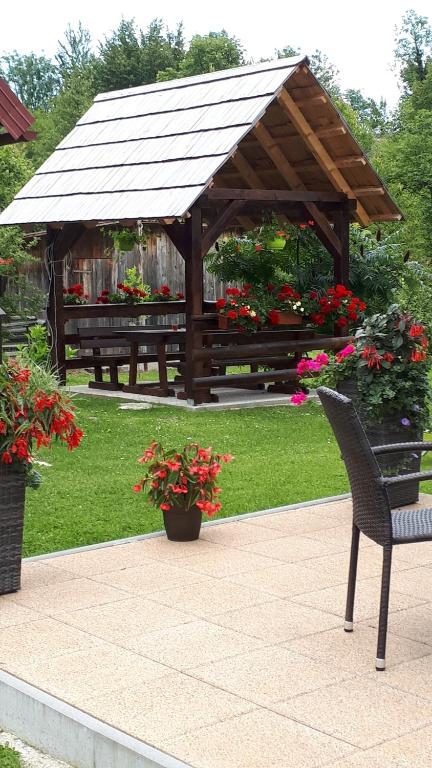 拉斯托瓦卡Apartment Perić的一个带长凳和鲜花的木制凉亭