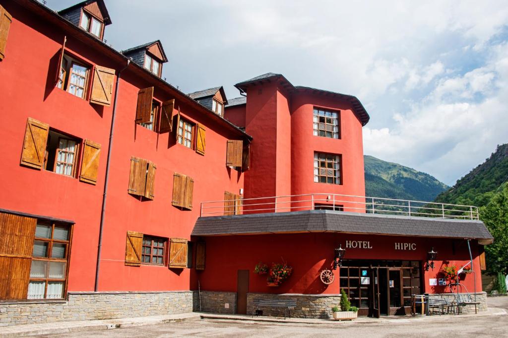 维耶拉西皮客酒店的一座红色的建筑,上面设有一个阳台
