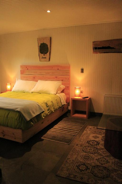 内尔图梅Treca Rupan Lodge的一间卧室配有一张带两盏灯的床。