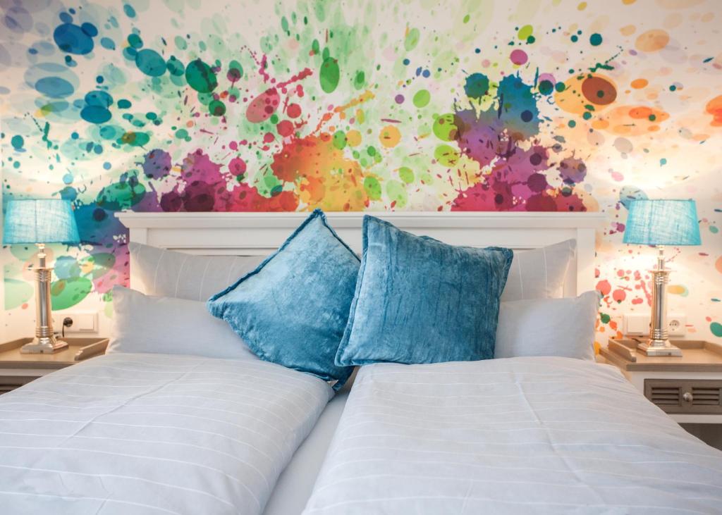 温特贝格Die Sperre的卧室配有白色床和色彩缤纷的墙壁