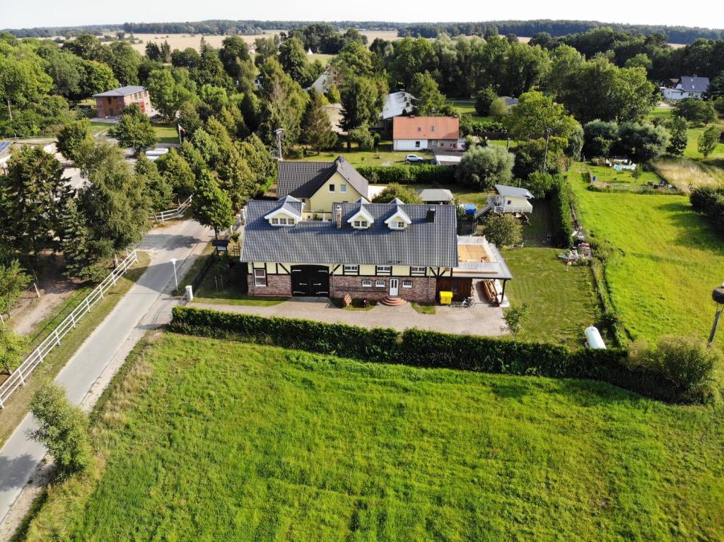 Kloster WulfshagenLandhaus zum Storchennest的绿色田野上房屋的空中景观