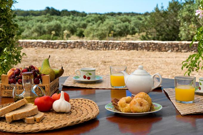 圣费兰-德瑟斯罗Ca Na Maria Teueta的餐桌,早餐包括面包和橙汁