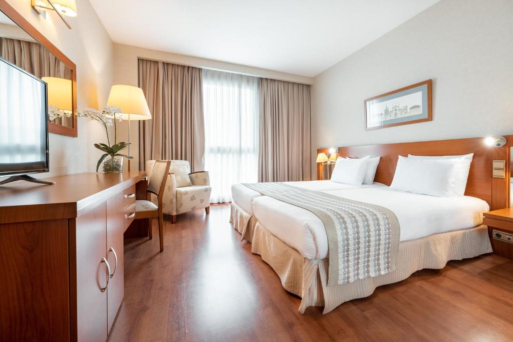 圣地亚哥－德孔波斯特拉欧洲之星圣拉萨罗酒店的配有一张床和一台平面电视的酒店客房