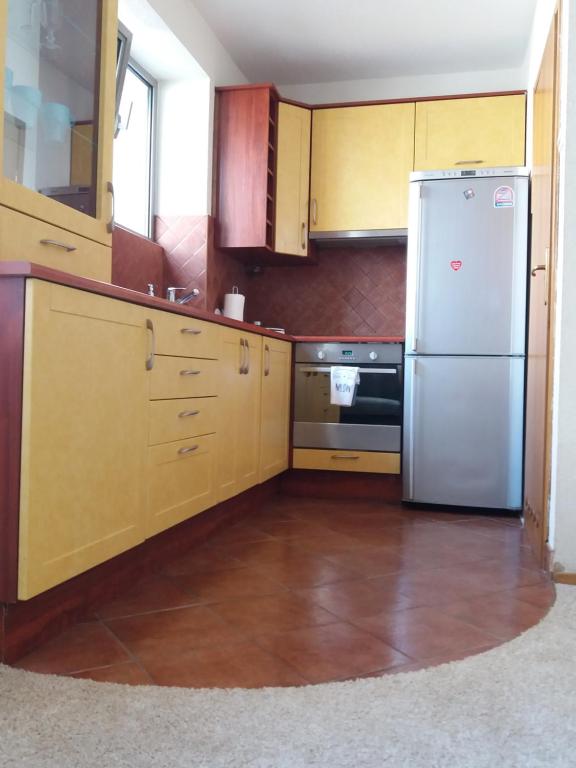 哈伊努夫卡Apartament的厨房配有木制橱柜和不锈钢冰箱。