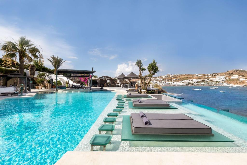 奥诺斯米科诺斯方舟酒店的一个带躺椅的游泳池和海洋