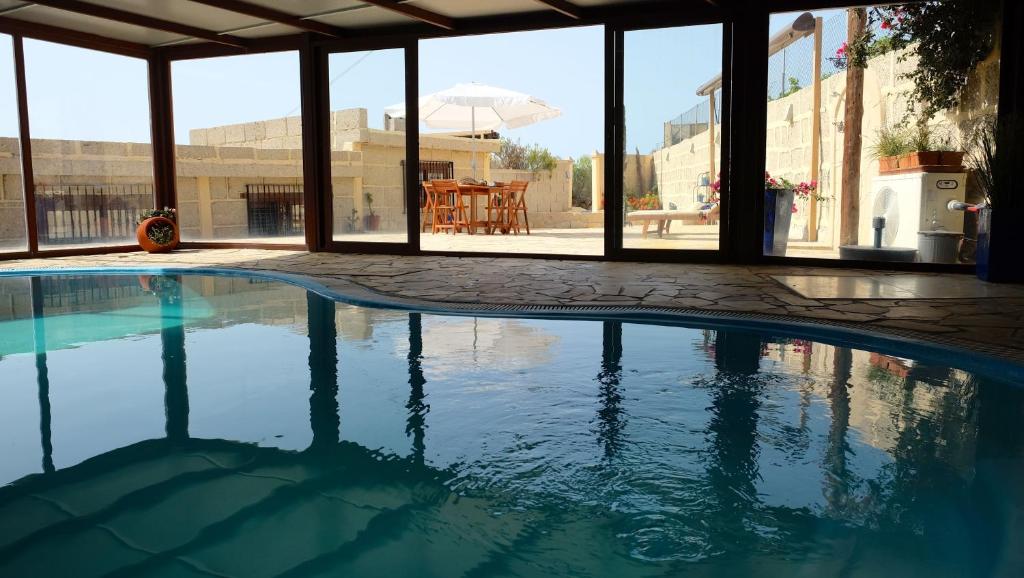 La DegolladaCasa en finca de uva con piscina privada, cubierta y climatizada的一座建筑物中央的游泳池
