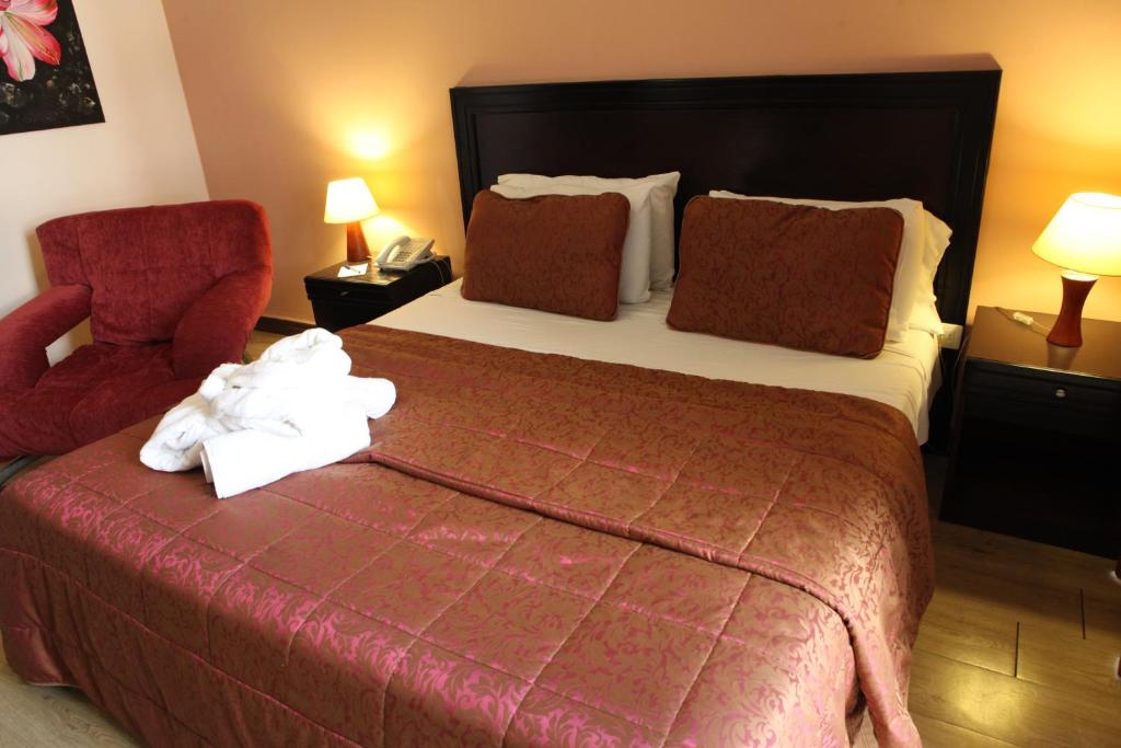 贝鲁特莫扎特酒店的酒店客房,配有一张床和一张红色椅子