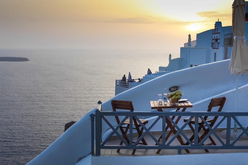 伊亚White Side Suites的俯瞰大海的游轮边的桌子