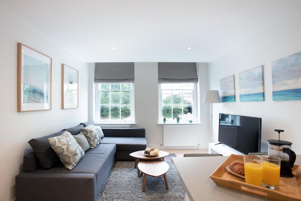温莎Hampden Apartments - The George的客厅配有沙发和桌子
