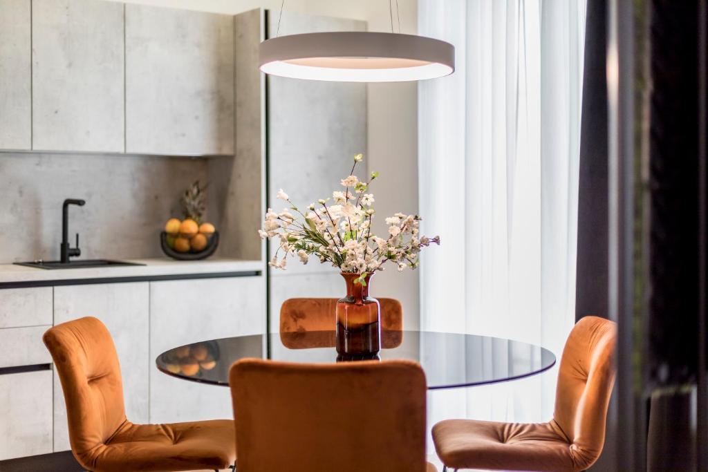 斯普利特Monvi Luxury Suites的餐桌、椅子和花瓶