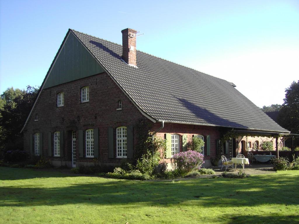 博霍尔特Bauernhof Barlo的黑色屋顶的大型砖屋