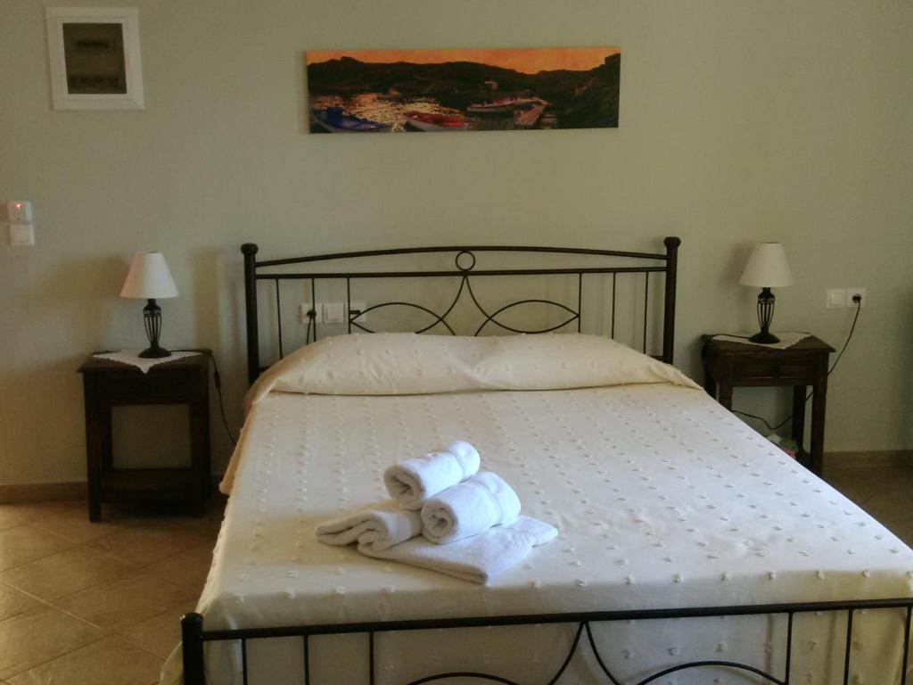Kálamos KythiraVilana Studios的一间卧室配有一张床,上面有两条可移动的毛巾