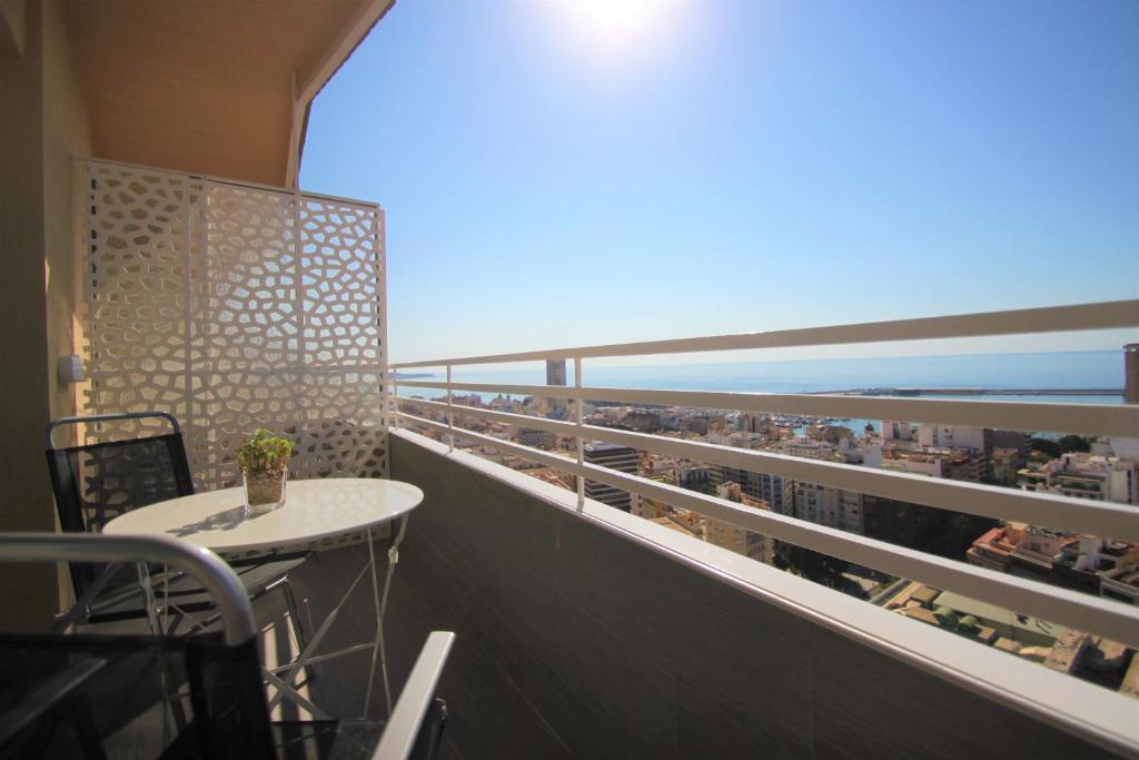 阿利坎特CasaTuris Estudio vistas increíbles en Centro de Alicante A115的阳台配有桌子,享有海滩美景