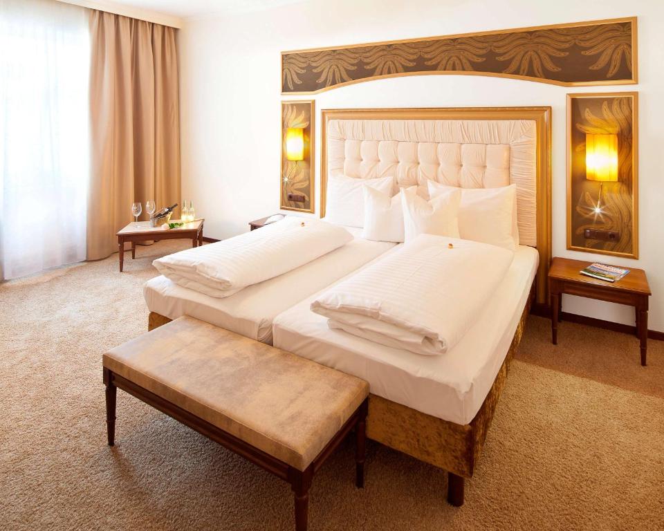 因斯布鲁克最佳西方因斯布鲁克阿德勒戈尔登酒店的一间带两张床和大床头的大卧室