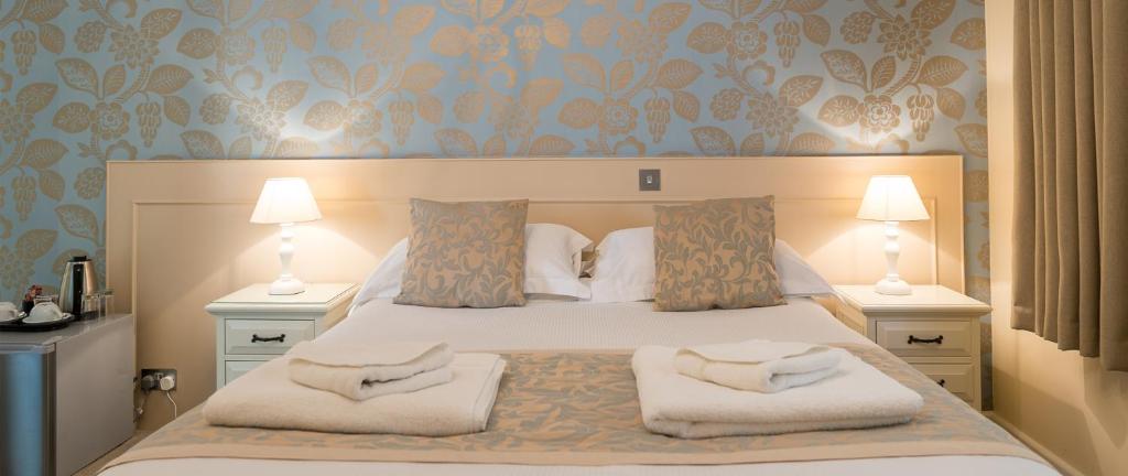 GrouvilleMaison Gorey Hotel的一间卧室配有一张带两个枕头的床