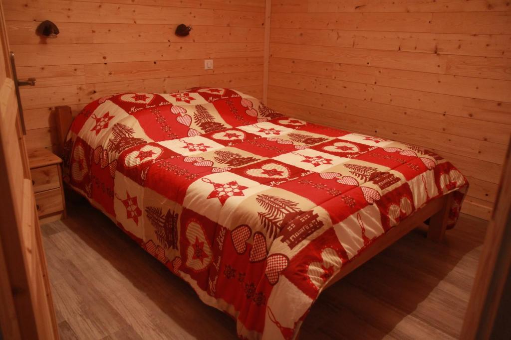 尚帕尼恩瓦努瓦茲la ratavelaiza的木制客房内的一间卧室,配有一张床