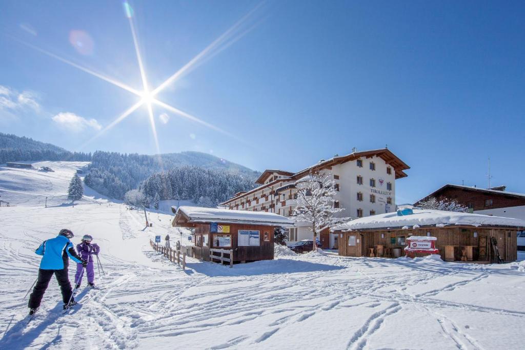 奥贝劳Landhotel Tirolerhof - Mai bis Mitte Juni kein Saunabetrieb的一群滑雪者在滑雪小屋滑雪