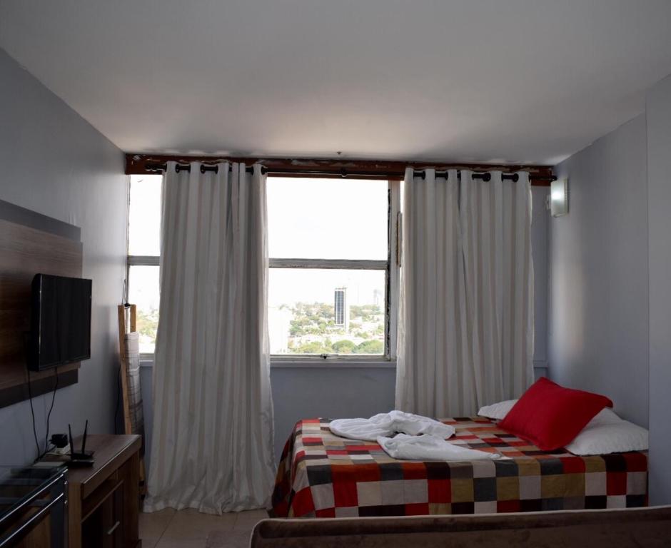 戈亚尼亚Apartamento confortável的一间卧室设有一张床和一个大窗户