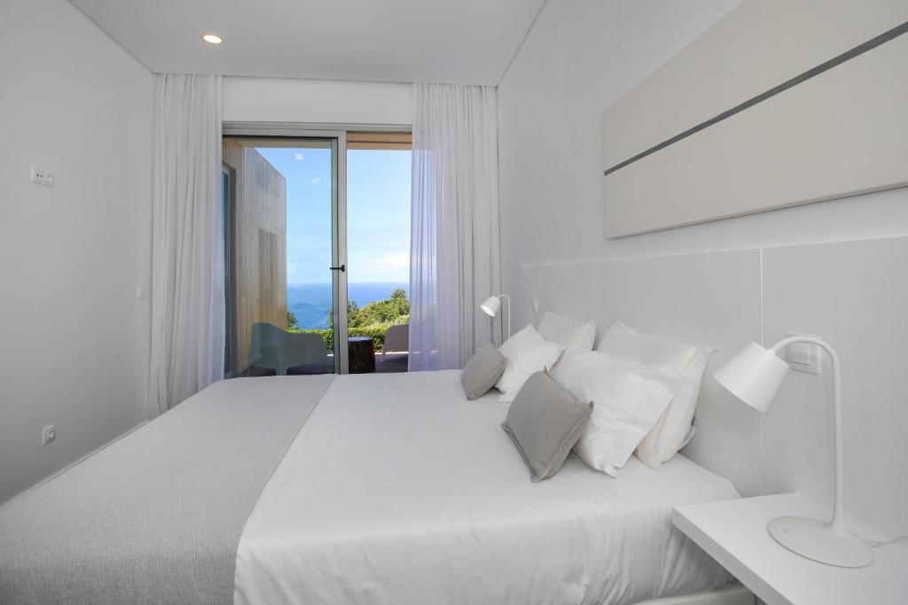 莫什泰鲁什Mosteiros Place的白色卧室配有白色大床和白色枕头