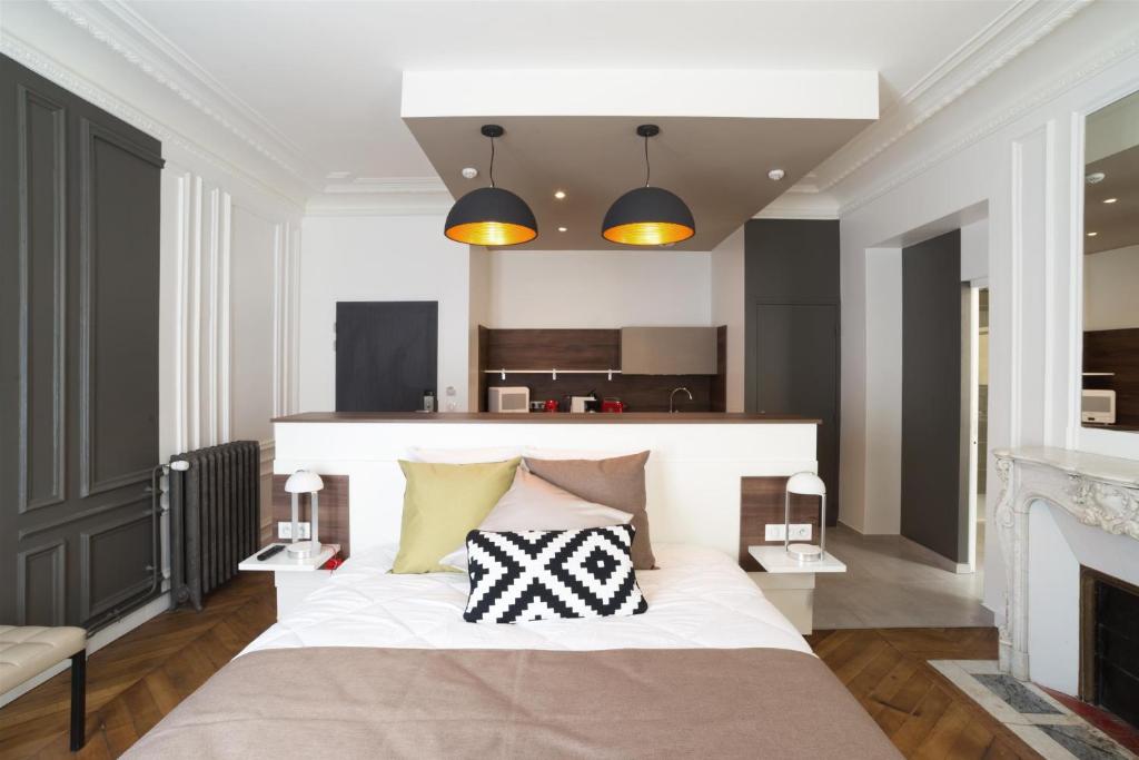 巴黎Les cles du 27 Paris的一间卧室配有一张大床和两个枕头