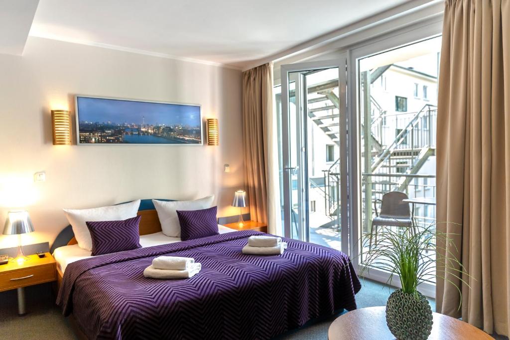 柏林柏林安比特酒店的酒店客房设有一张床和一个阳台。