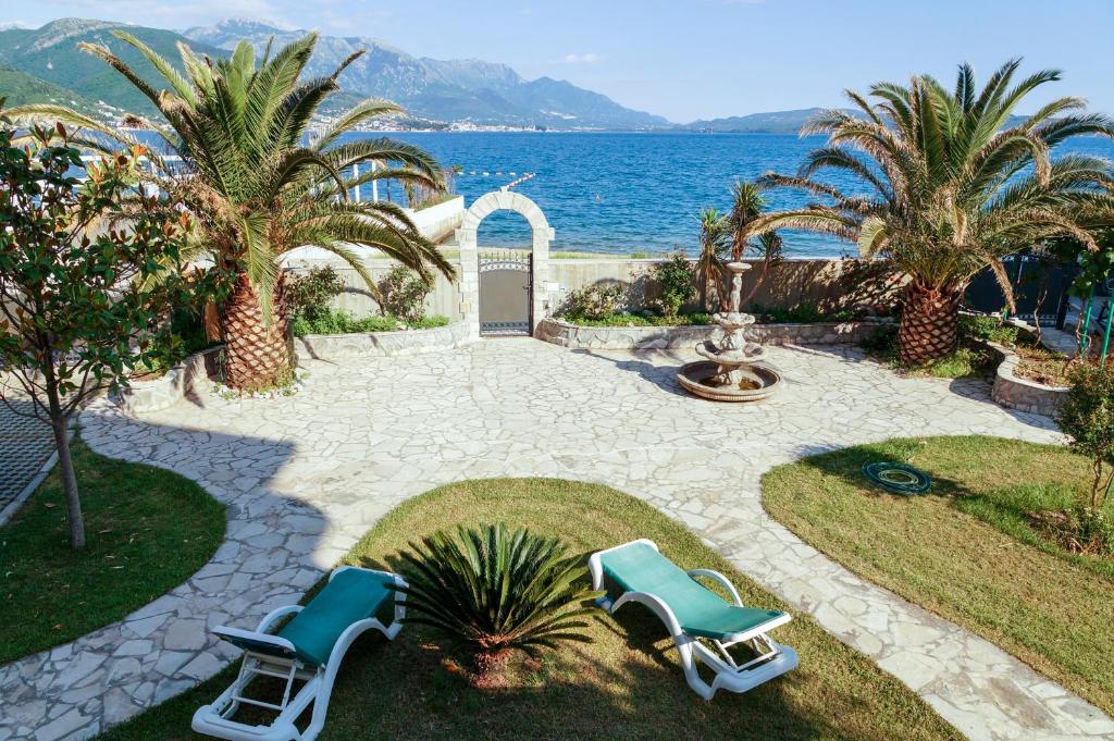 比耶拉Apart Hotel Apple Cat Montenegro KO Bijela的一个带2把躺椅的庭院和大海