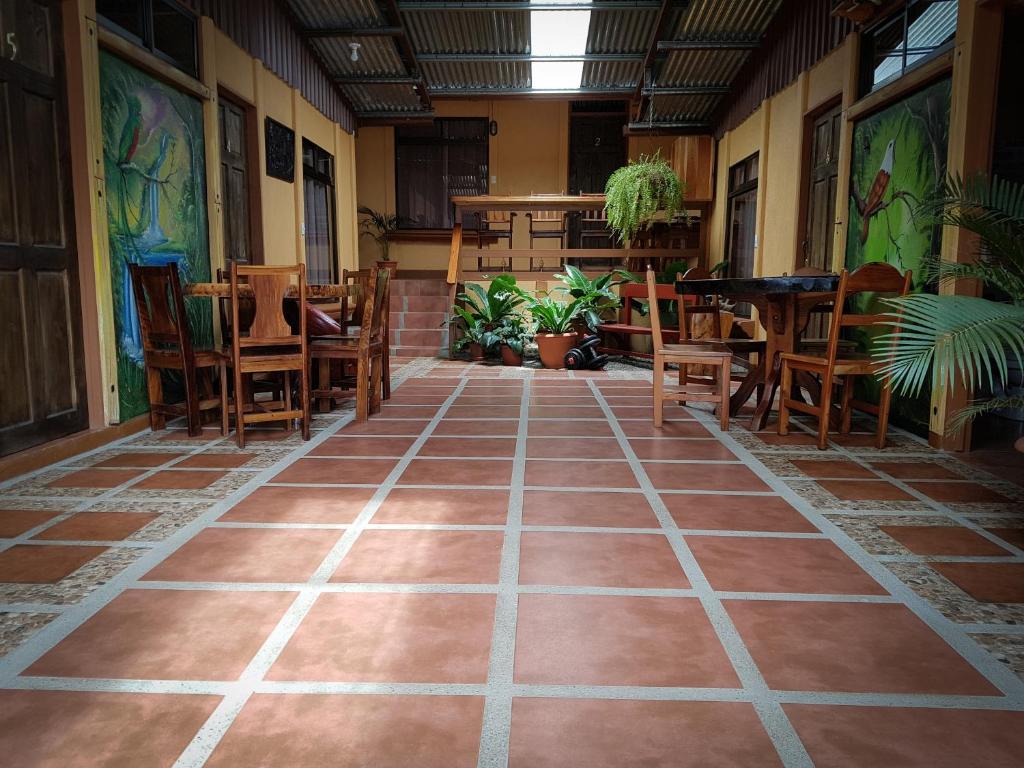 蒙泰韦尔德哥斯达黎加Greemount Hotel的一间空房,配有桌椅,铺有瓷砖地板