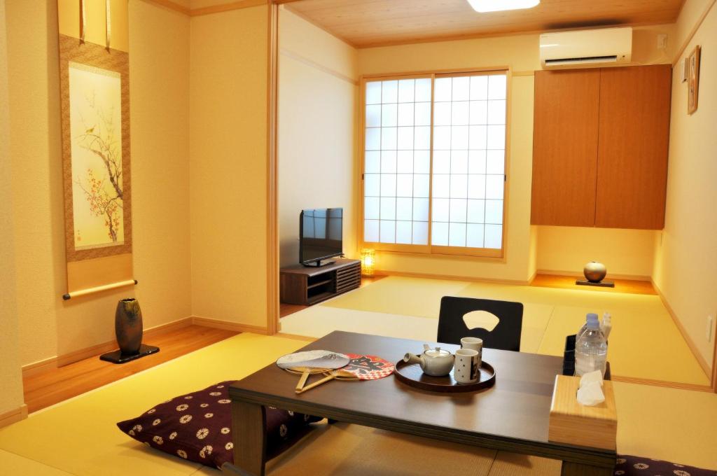 大阪harper house传统日式旅馆的客厅配有桌子和电视